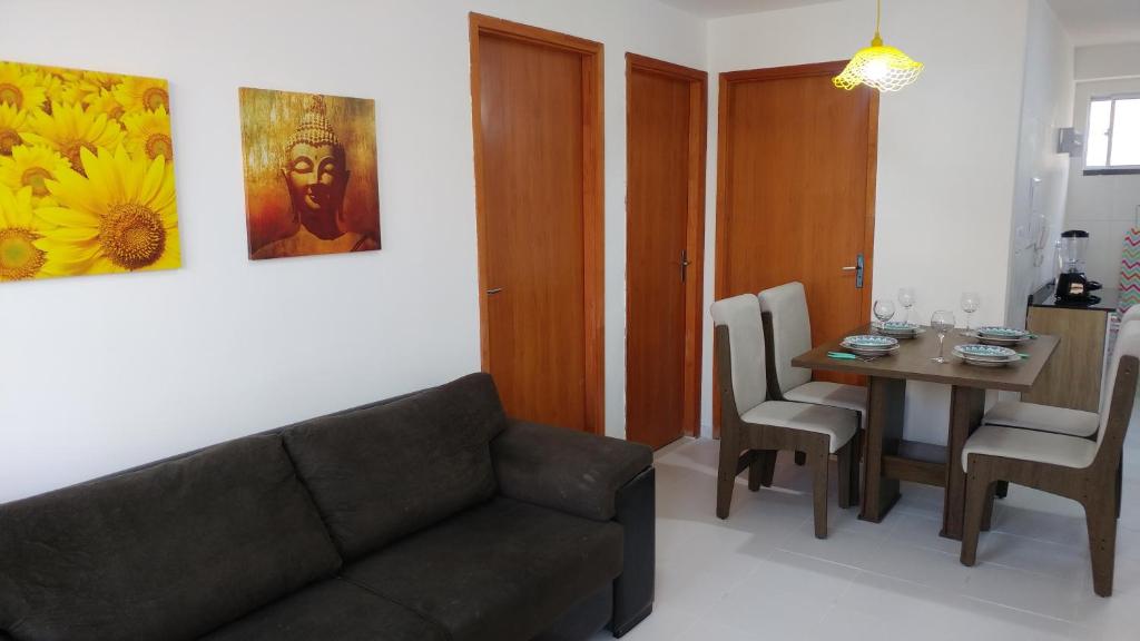 a living room with a couch and a table at Condomínio Residencial Tranquilidade na Beira do Rio in Paulo Afonso