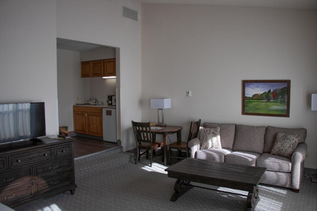 a living room with a couch and a table at Lone Tree Golf Club and Hotel in Lone Tree