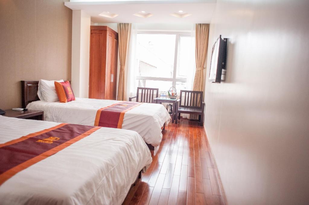 Postel nebo postele na pokoji v ubytování Mely Hotel Hà Nội