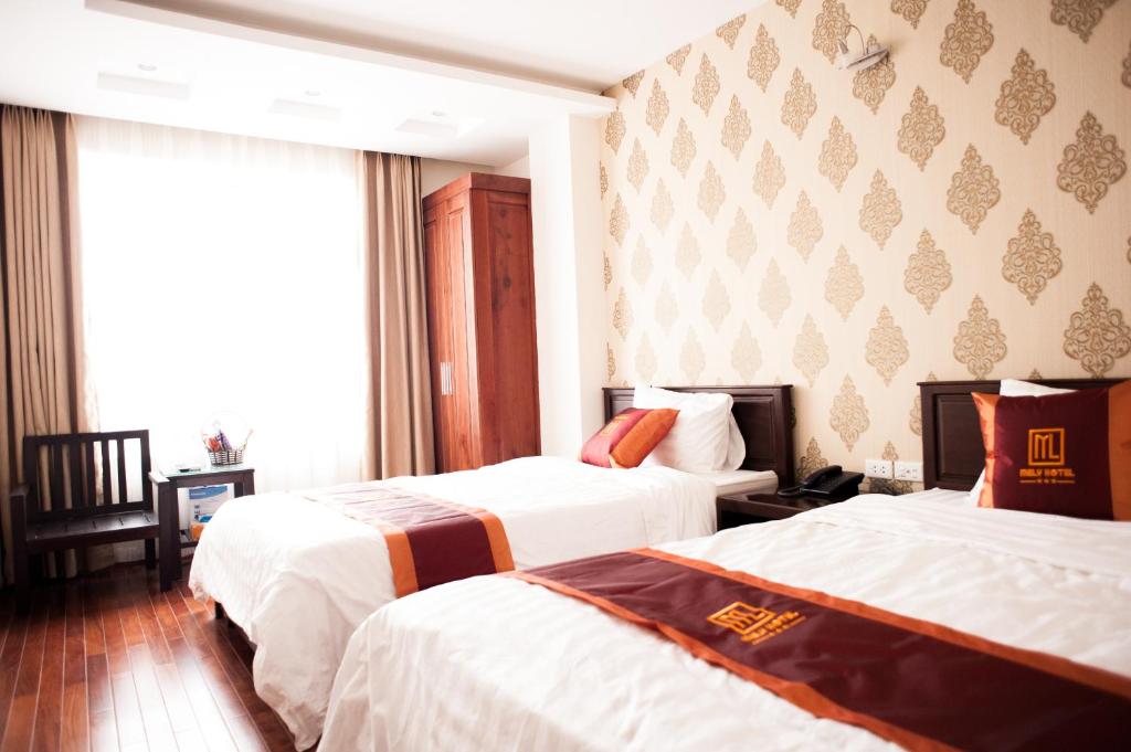 Postel nebo postele na pokoji v ubytování Mely Hotel Hà Nội