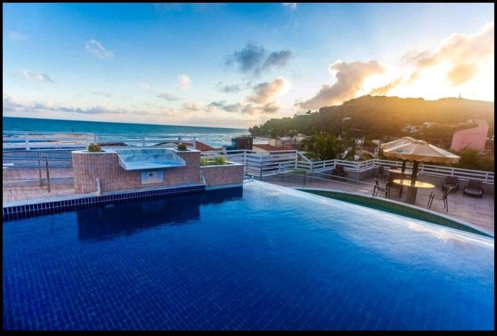 uma grande piscina com vista para o oceano em Pipas Bay - FLAT BEIRA MAR em Pipa