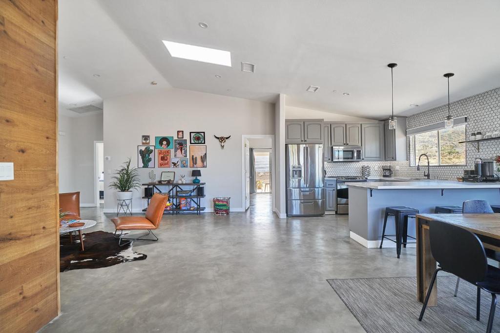 an open kitchen and living room with a table and chairs at Eclectic Joshua Tree in Joshua Tree