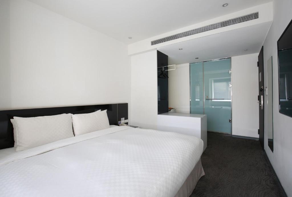 Postel nebo postele na pokoji v ubytování CityInn Hotel Plus - Taichung Station Branch