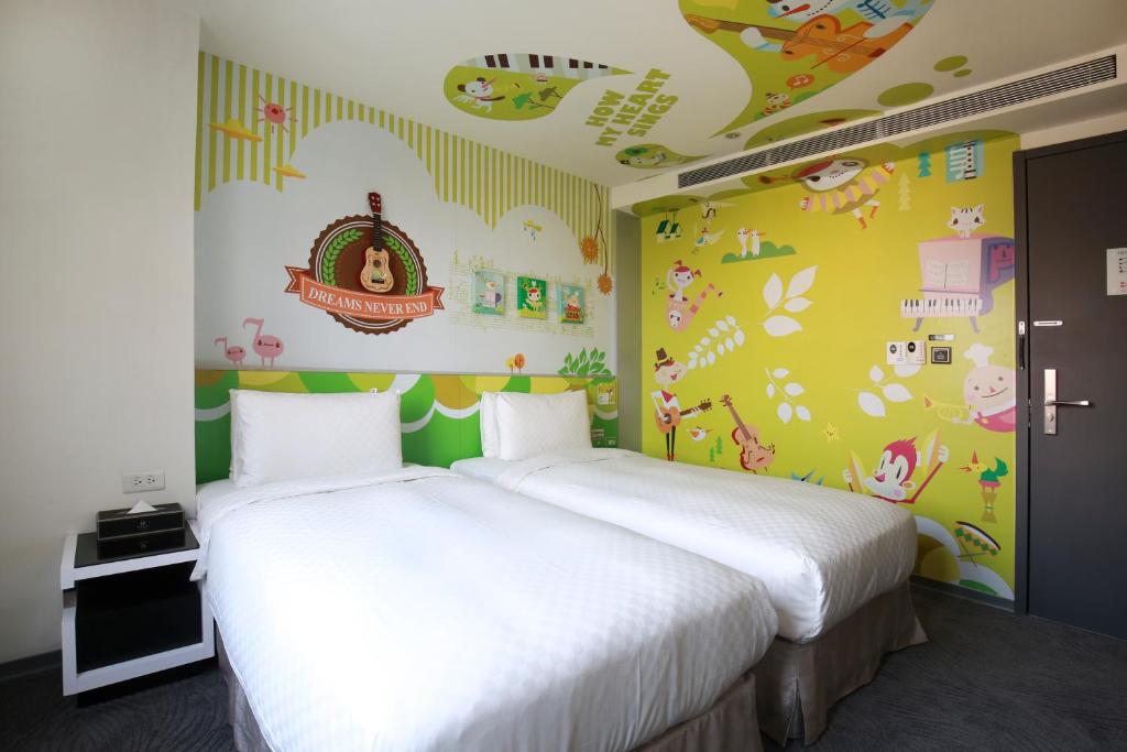 Postel nebo postele na pokoji v ubytování CityInn Hotel Plus - Taichung Station Branch