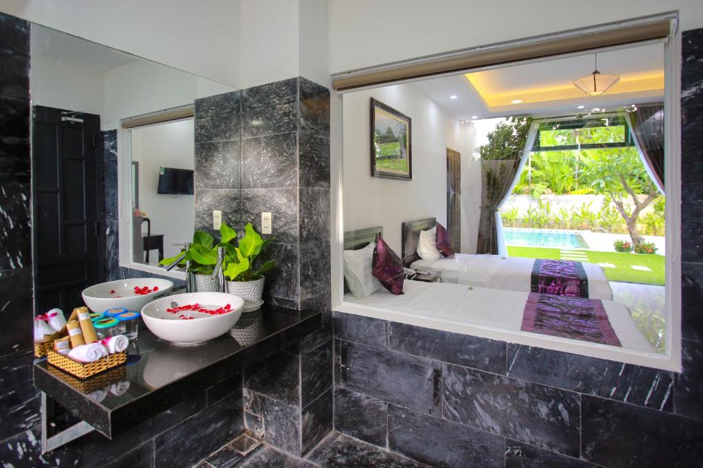 Cama o camas de una habitación en Hoi An Hideaway Villa