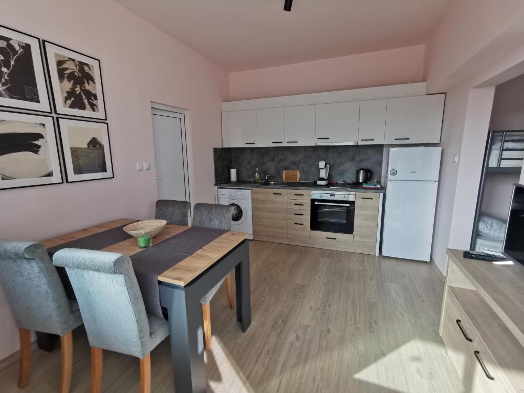 a kitchen with a table and chairs in a room at Studio Thermi 1 in Varna City