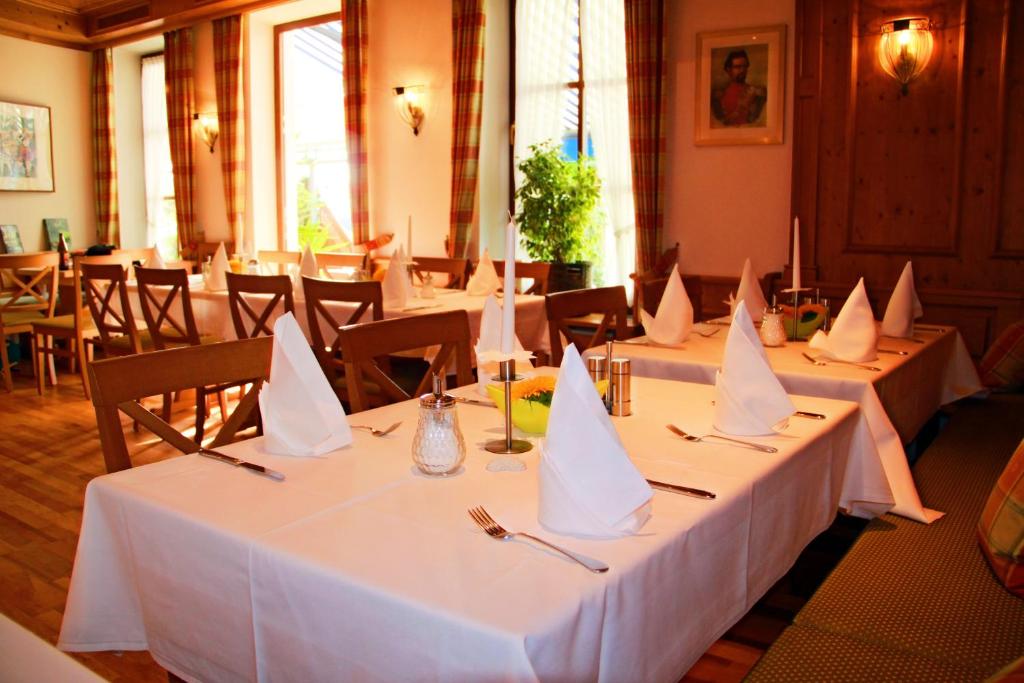 a group of tables with napkins on them in a restaurant at Hotel Häußler in Langenbruck