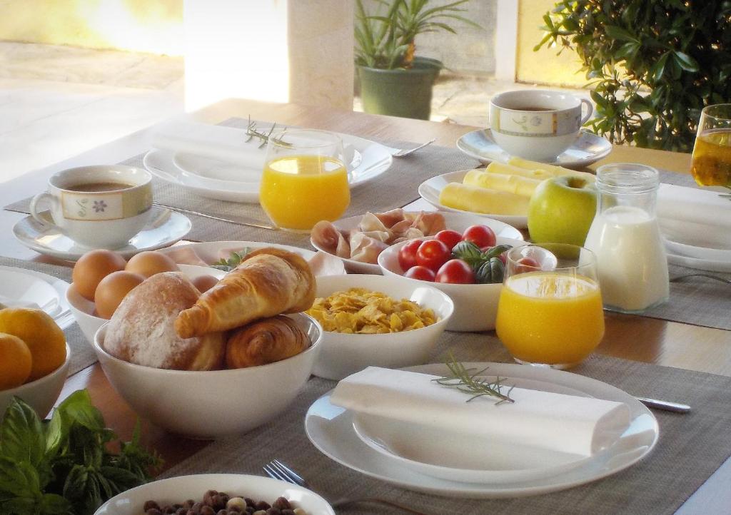 a table with a breakfast of eggs bread and fruit at Villa Laguna in Lumbarda