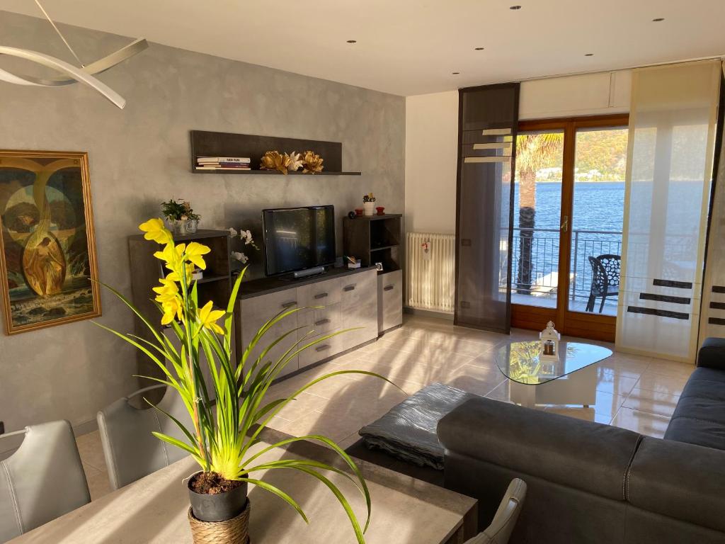 a living room with a couch and a table at apartment Lac Brusimpiano in Brusimpiano