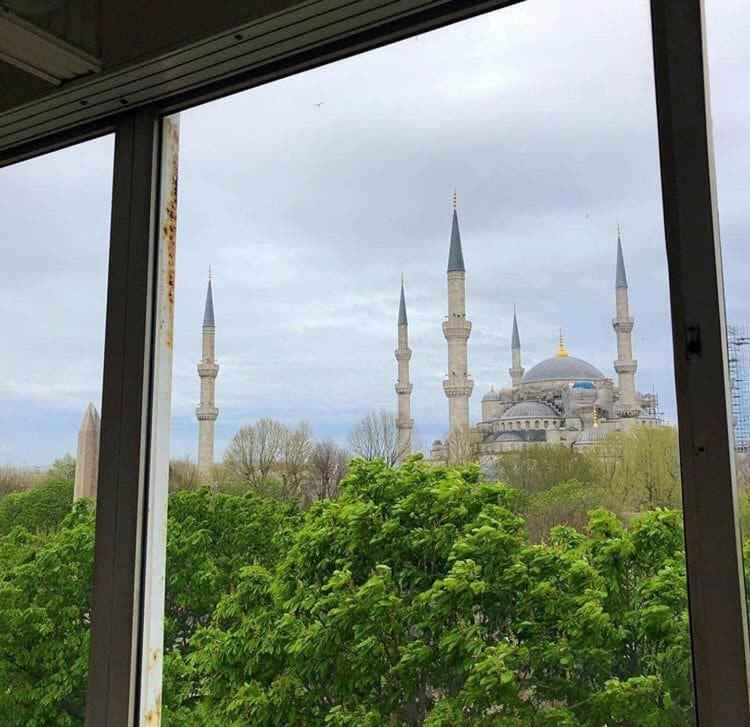 a view of a mosque from a window at Optimist Hotel in Istanbul