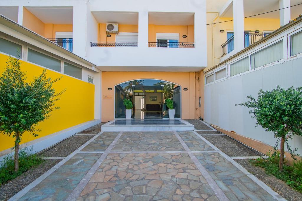 a hallway of an apartment building with a yellow wall at Matthias Hotel Apartments in Adelianos Kampos