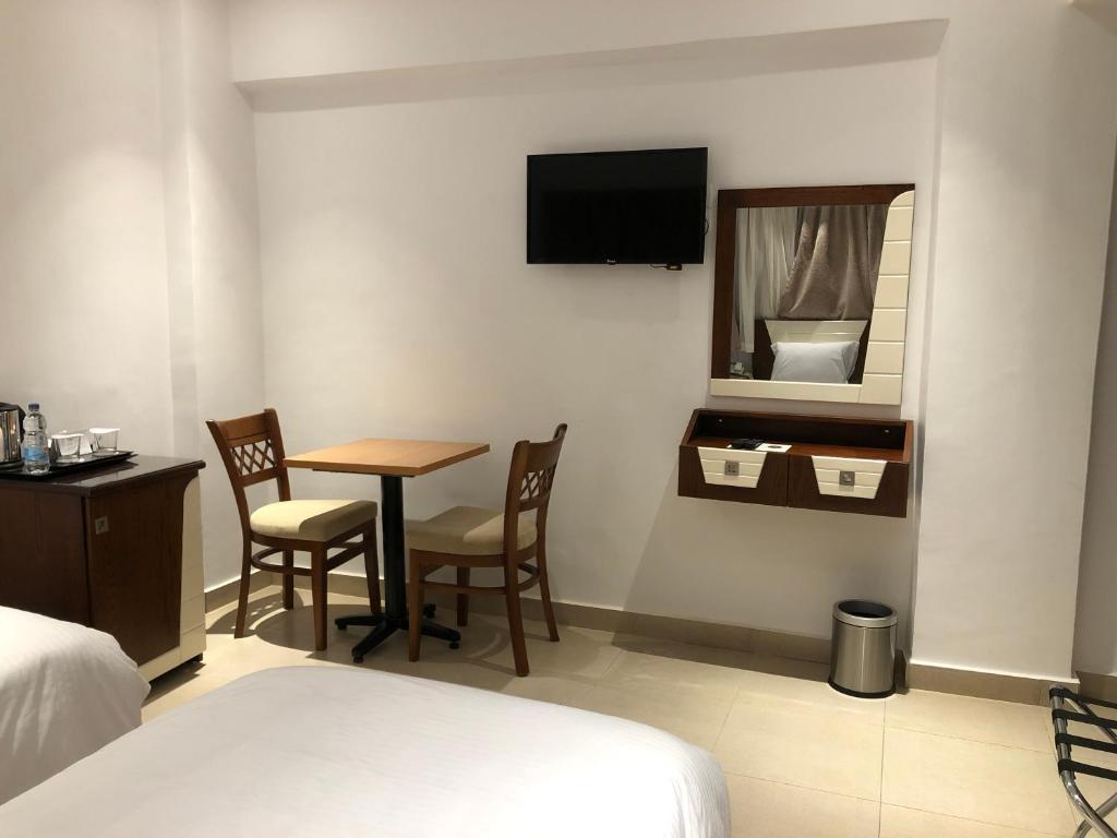 Postel nebo postele na pokoji v ubytování Maxim Hotel
