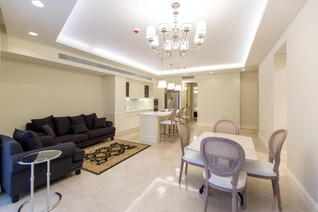 a living room with a couch and a table and chairs at SUITE WA B1 - WALDORF ASTORIA RESIDENCES - JERUSALEM-RENT in Jerusalem