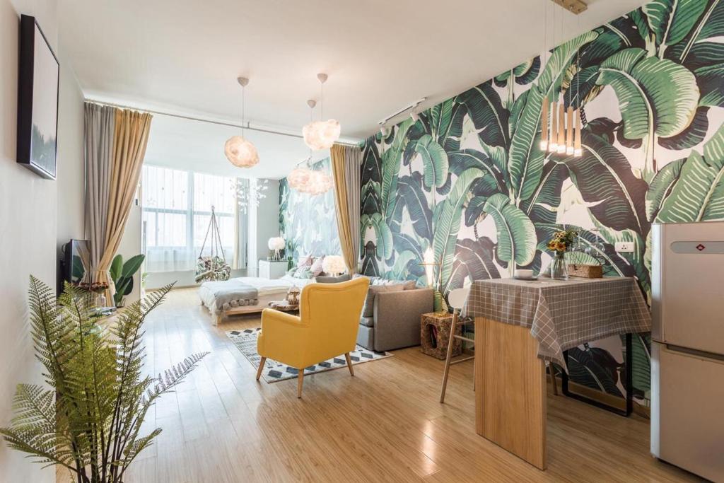 a living room with a tropical mural on the wall at Jiangan Jianghan Road Pedestrian Street Locals Apartment 00116680 in Hankou