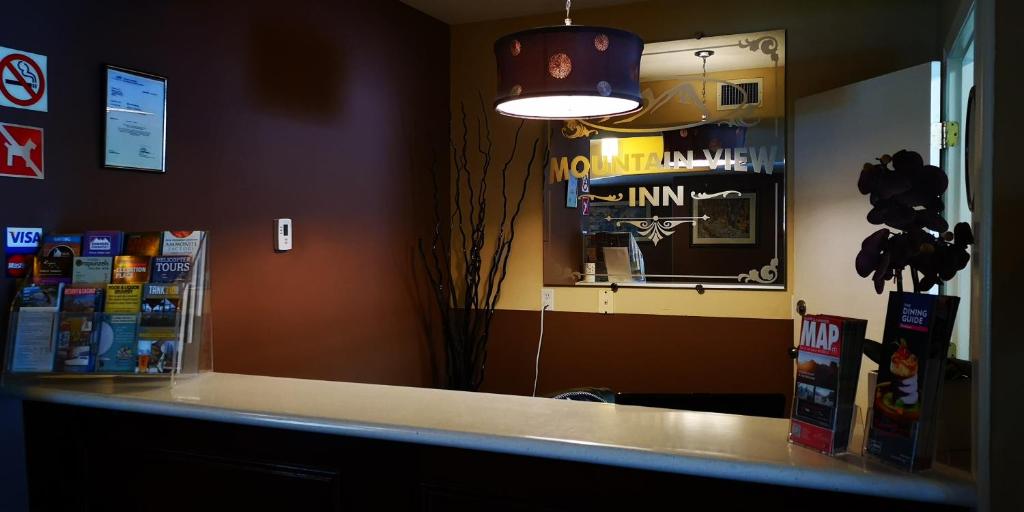 a counter in a store with a light above it at Mountain View Inn in Canmore