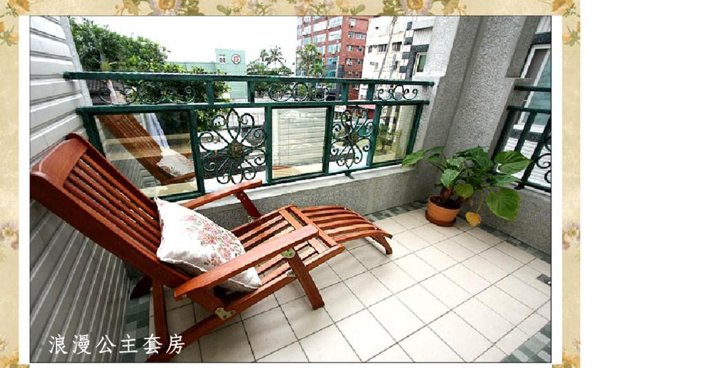 a balcony with two wooden chairs on a balcony at Hope &amp; Sea Homestay in Hualien City