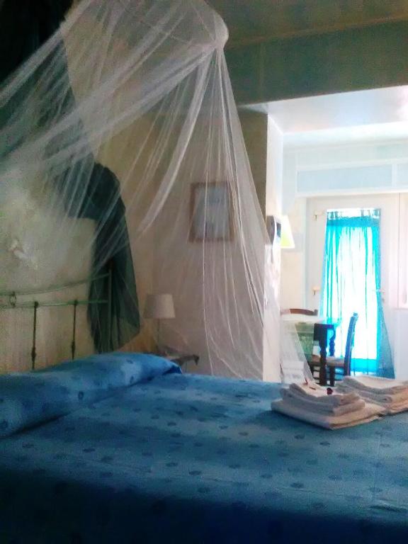 Кровать или кровати в номере La Casa di Ulisse B&B