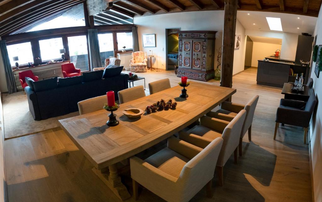 a dining room with a wooden table and chairs at RÉSIdence Reith Kitzbühel in Kitzbühel