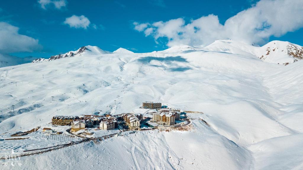 a resort on top of a snow covered mountain at NEW GUDAURI ATRIUM 336 in Gudauri