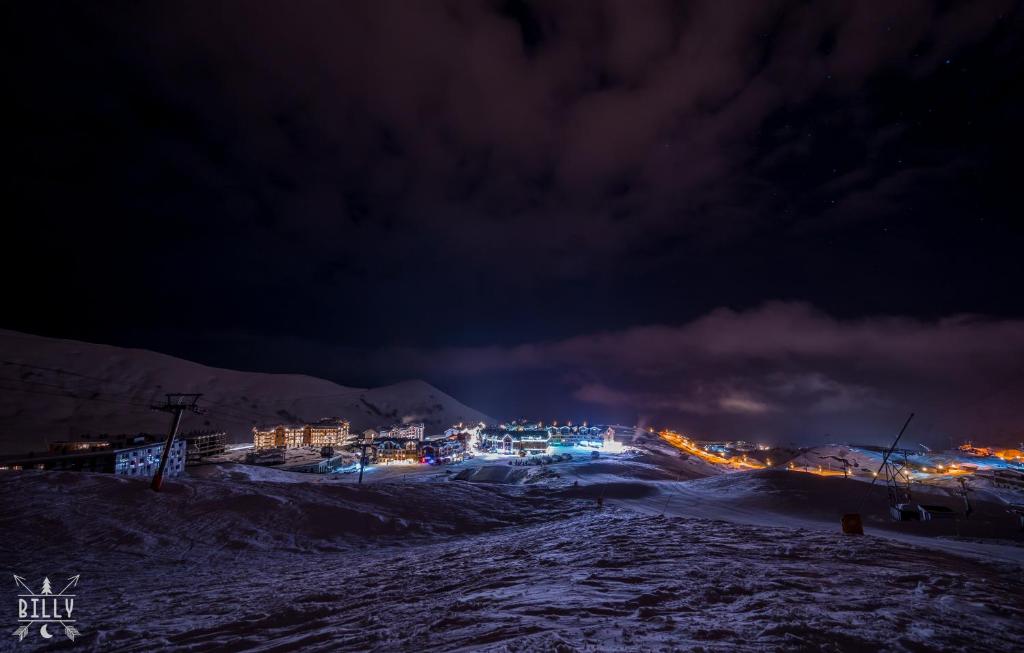 a city at night with snow and lights at NEW GUDAURI ATRIUM 336 in Gudauri