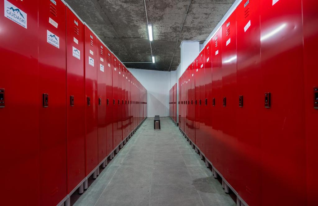 a long hallway with red lockers in a gym at NEW GUDAURI ATRIUM 336 in Gudauri