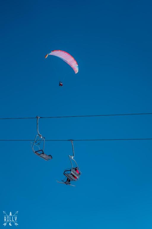 a person flying a kite in the sky at NEW GUDAURI ATRIUM 336 in Gudauri