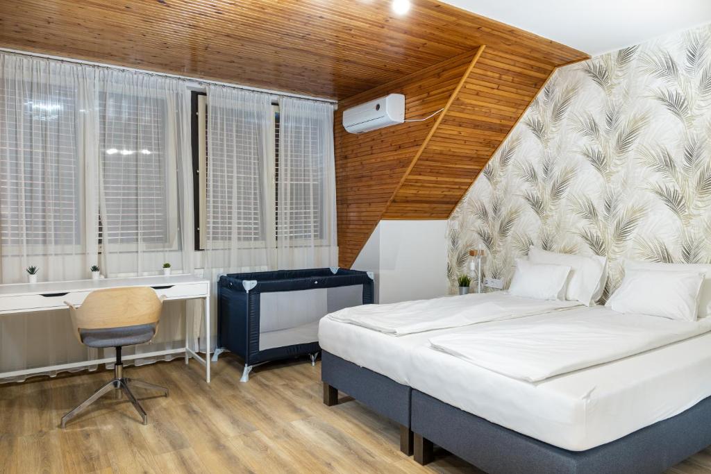 Postel nebo postele na pokoji v ubytování Tiszapart-Vendégház