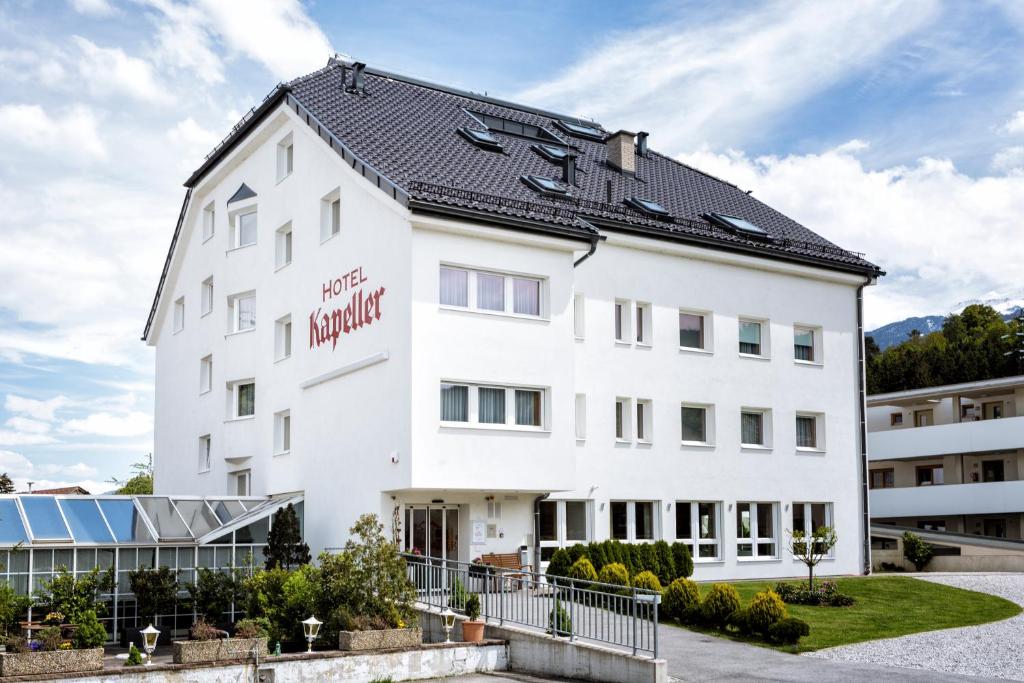 
a large white building with a large window at Hotel Kapeller Innsbruck in Innsbruck
