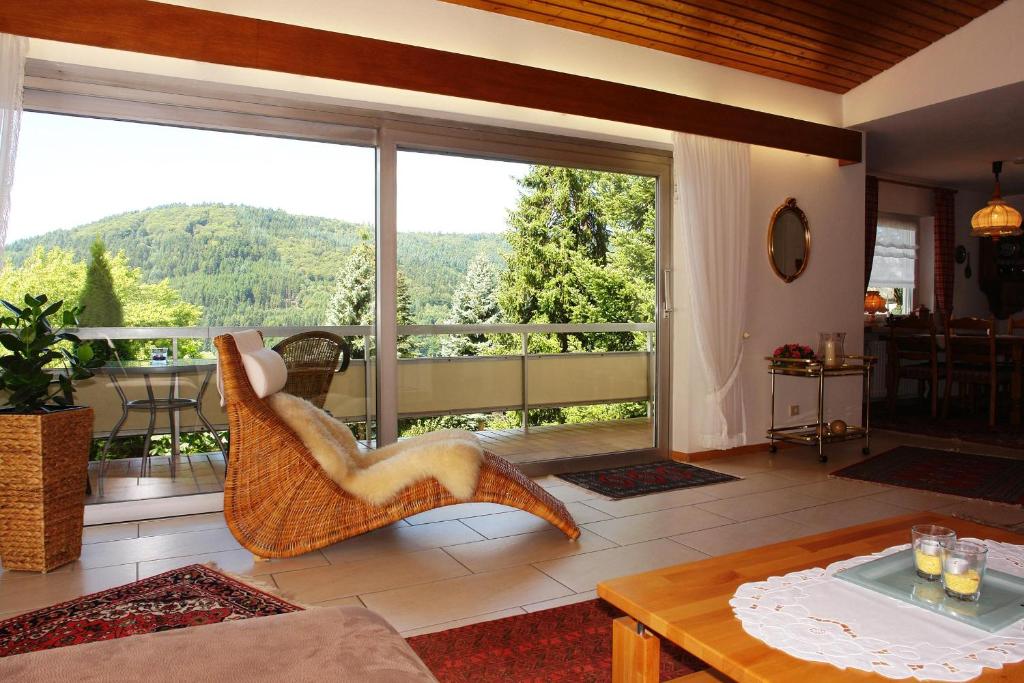 a living room with a large window with a view at Schwarzwälder Ferienwohnungen in Seelbach