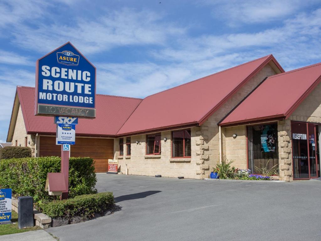 a sign for a service route motor lodge in front of a building at ASURE Scenic Route Motor Lodge in Geraldine