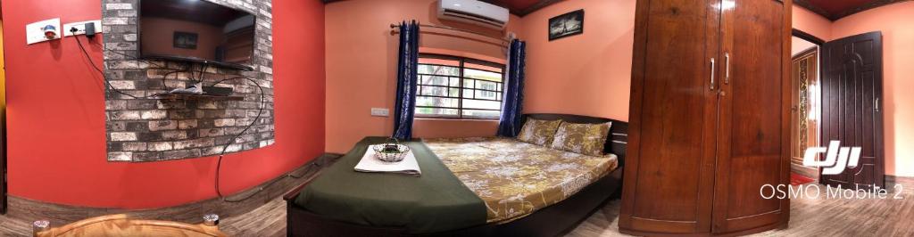 a room with a bed in the corner of a room at 12 Homestay Apartments in Siliguri