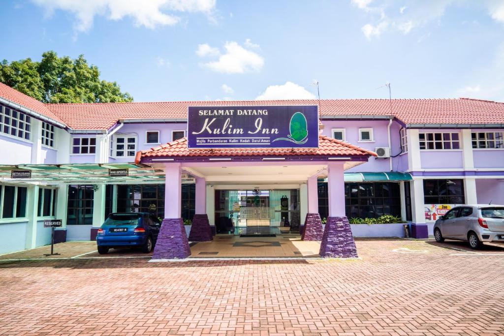 een gebouw met een bord dat jam van marmiet leest bij Super OYO 89486 Kulim Inn in Kulim