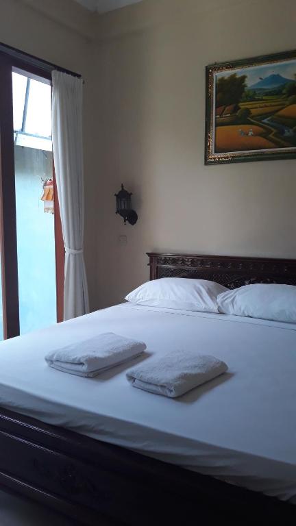 Postel nebo postele na pokoji v ubytování Baruna Guest House