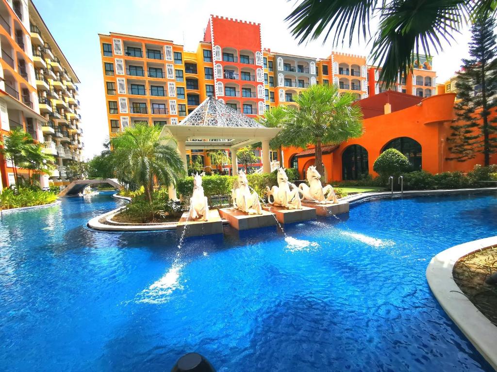 a swimming pool in a resort with statues in the water at D14 Venetian Condo Resort Pattaya Pool Connected Netflix in Jomtien Beach