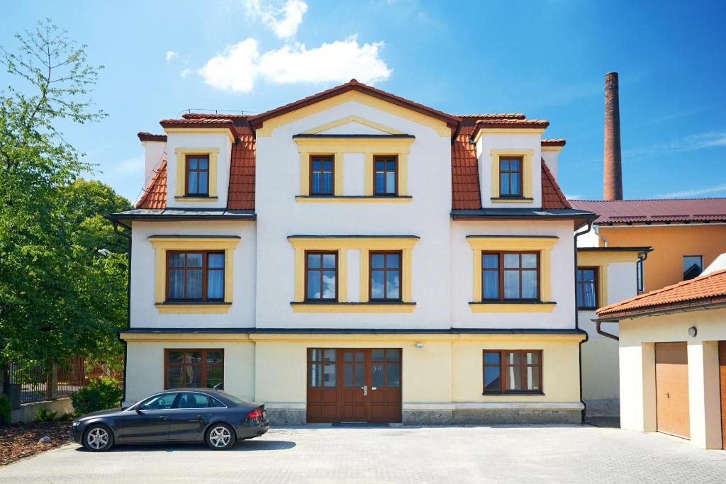 a house with a car parked in front of it at Vila Encore in Valašské Meziříčí