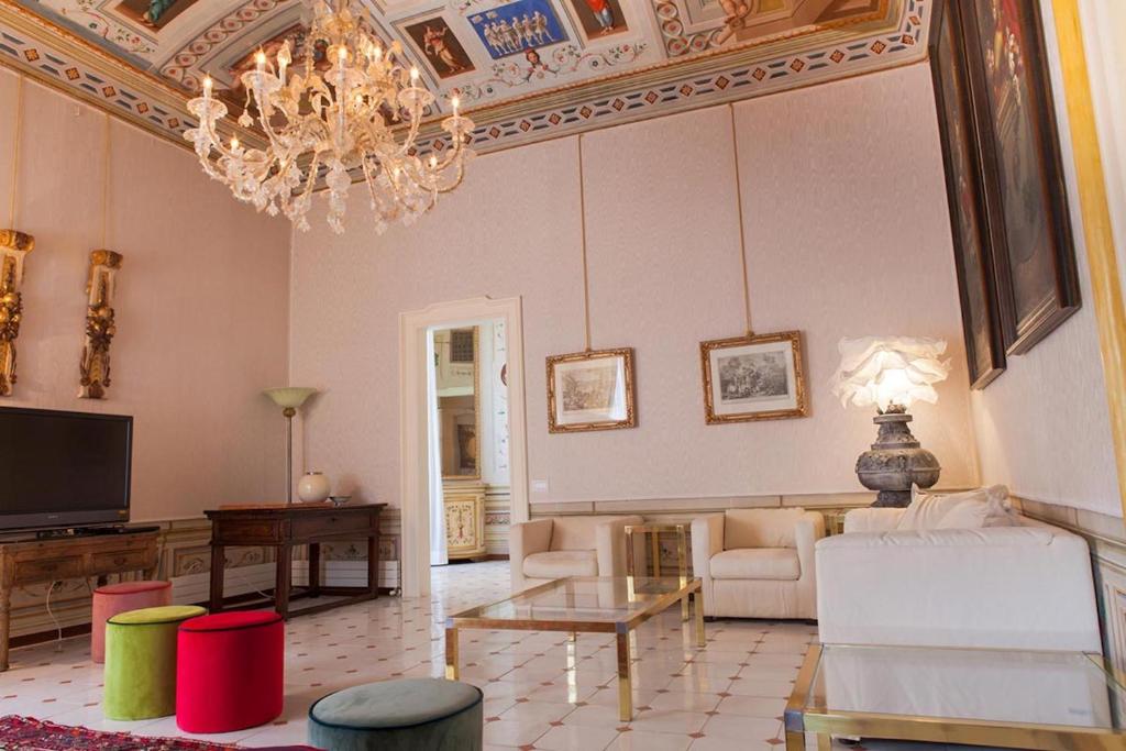 a living room with a chandelier and a couch at MarcheAmore - Stanze della Contessa, Luxury Flat with private courtyard in Fermo