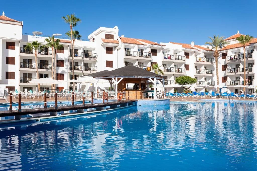 a swimming pool in front of a resort at Globales Tamaimo Tropical in Puerto de Santiago