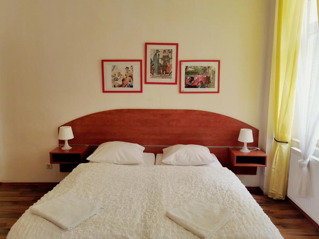 sypialnia z dużym białym łóżkiem z 2 lampami w obiekcie Apartment Amandment w Pradze
