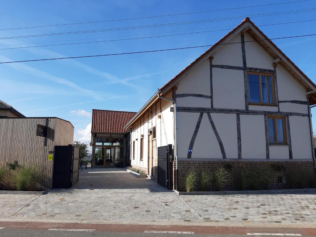 a white building with blue windows on a street at De Bonderbei in Wellen