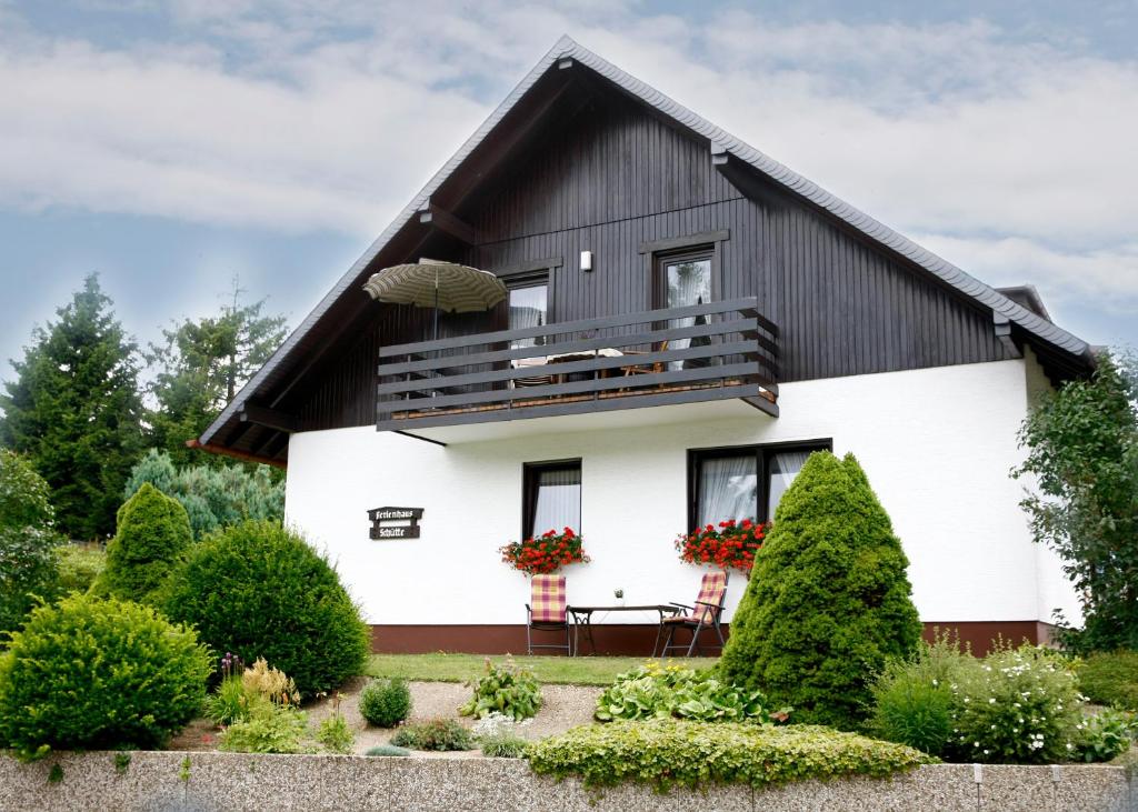 a white and black house with a black roof at Ferienwohnungen Annegret Schütte in Winterberg