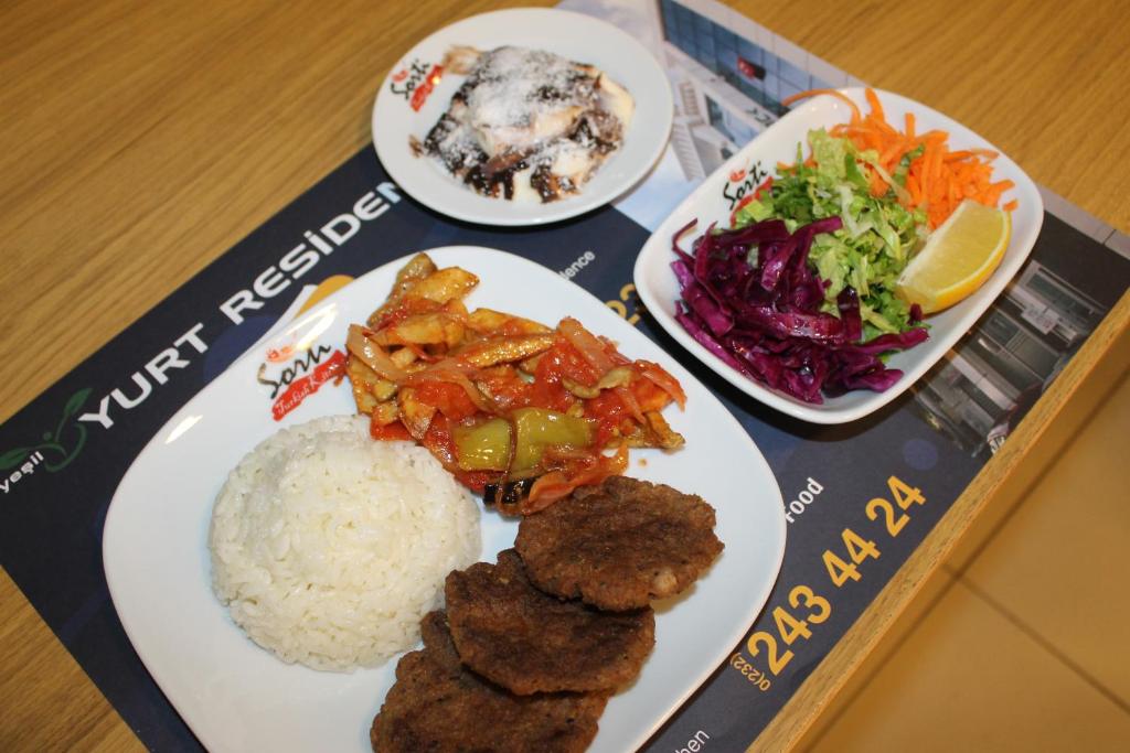 a plate of food with rice and vegetables on a table at Yeşilyurt Residence in İzmir