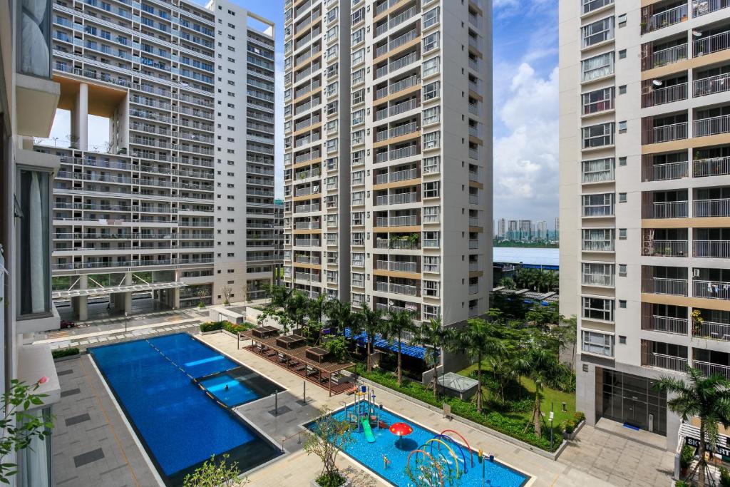 an apartment with a pool and two tall buildings at Scenic Valley Marvel in Ho Chi Minh City