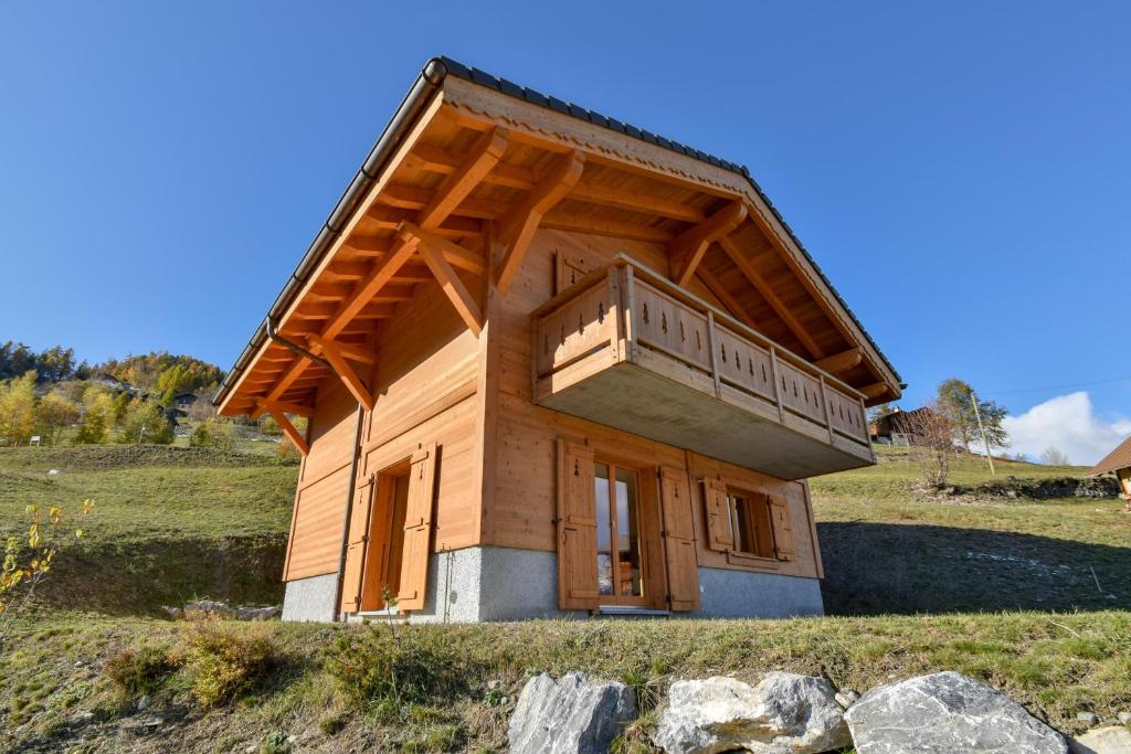 a small wooden building on top of a hill at Chalet Le Cerf - Newly build - WOW Views! in La Tzoumaz