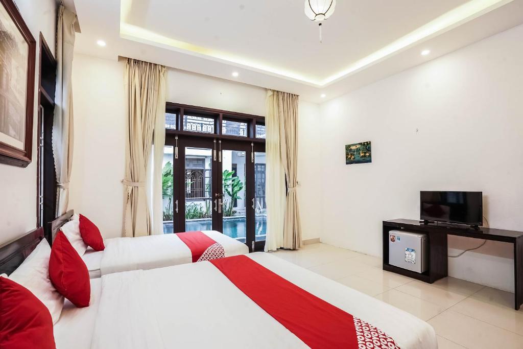 Postel nebo postele na pokoji v ubytování Almond Villa Hoi An