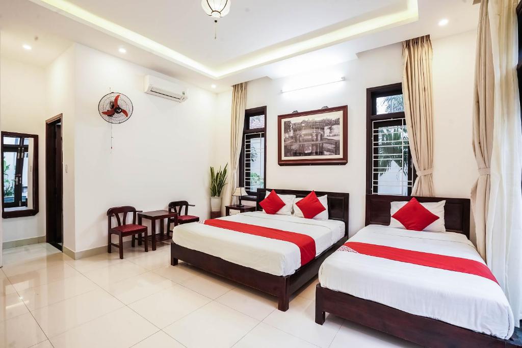 Postel nebo postele na pokoji v ubytování Almond Villa Hoi An