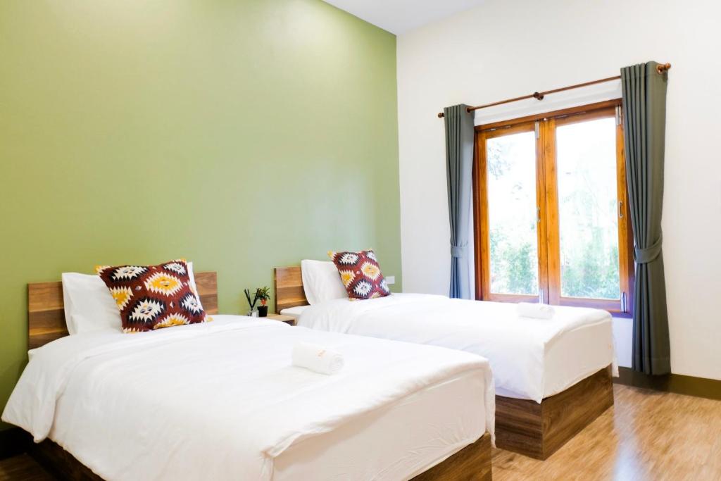 Postel nebo postele na pokoji v ubytování The Cozy Hotel