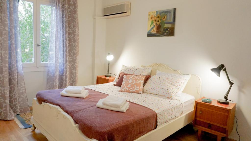 a bedroom with a bed with two towels on it at Comfortable Apartment in Kallithea by Athenian Homes in Athens