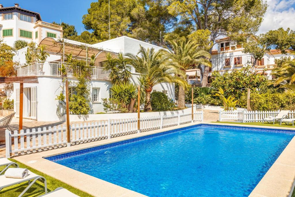 a swimming pool in front of a house at Villa Bellver in Palma de Mallorca