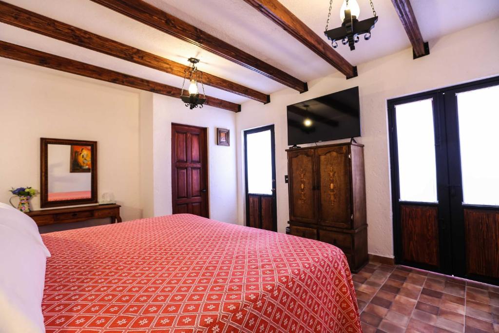 Postel nebo postele na pokoji v ubytování El mesón del Quijote