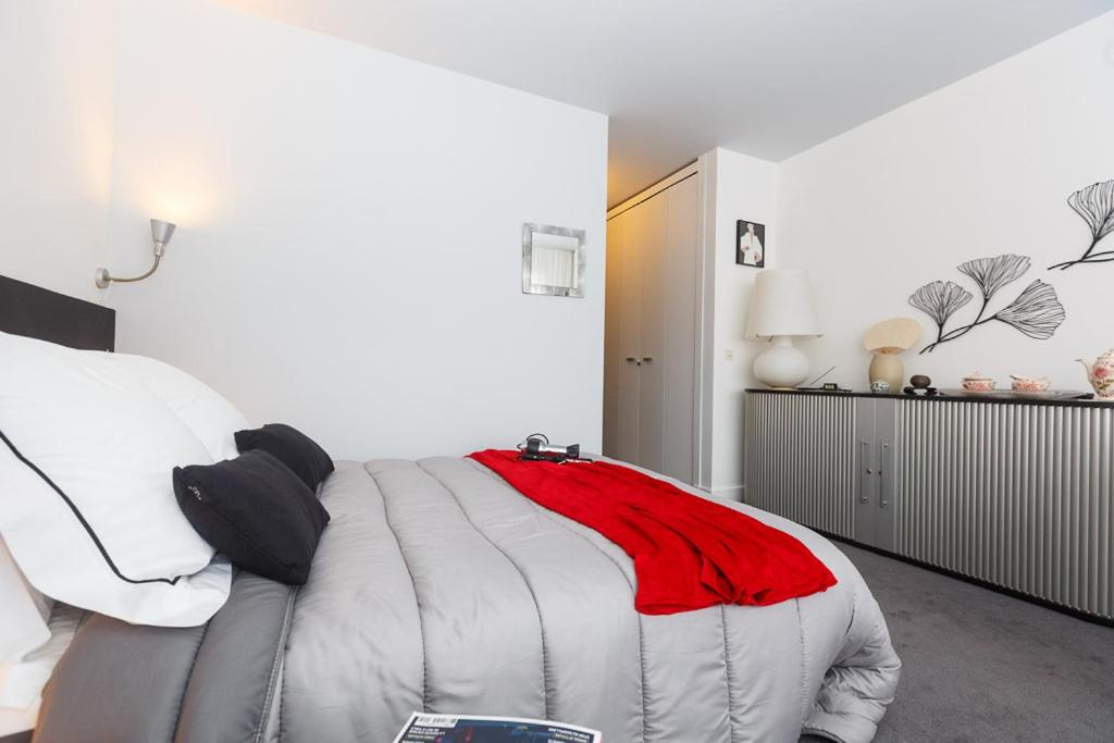 Un dormitorio con una cama con una manta roja. en B&B Junior Suite Paris Tour Eiffel en París